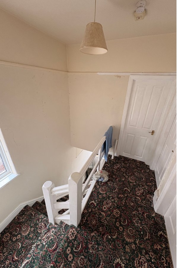Hallway before repaint – dated yellow walls, North Wales home